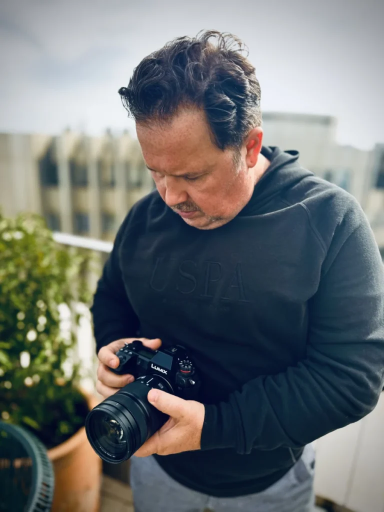 Denis Vila bereitet sich vor, einen Kunden für ein Imagefilm-Projekt zu fotografieren.